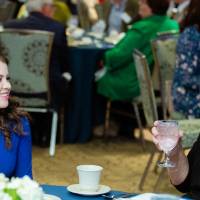 Two guests speaking to each other at a table at Scholarship Dinner 2019.